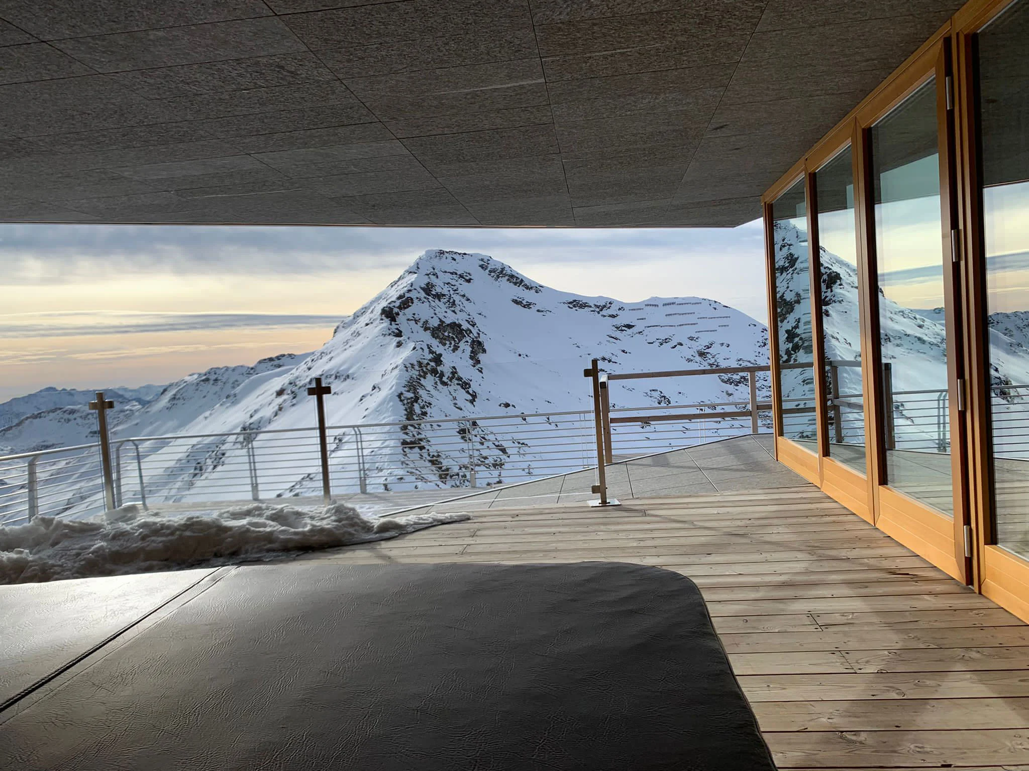 Terrazza coperta in legno dello chalet affacciata su una vetta innevata all'alba – Levissima 3000 Chalet, Valdisotto, Italia, 2018 – architettura