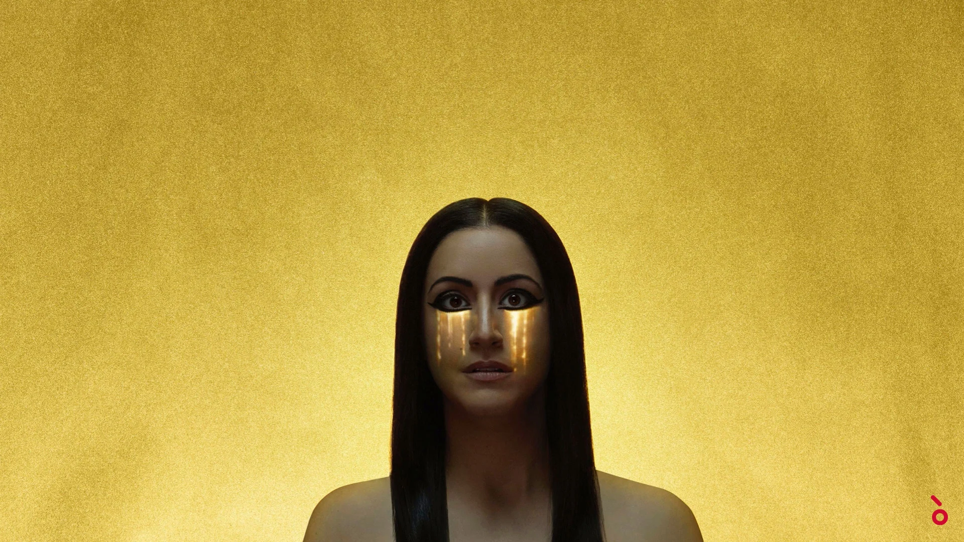 Opera video con una donna dal trucco egizio sugli occhi e lacrime dorate su sfondo oro – Aida alla Sydney Opera House, Australia, 2018 – scenografia d'opera