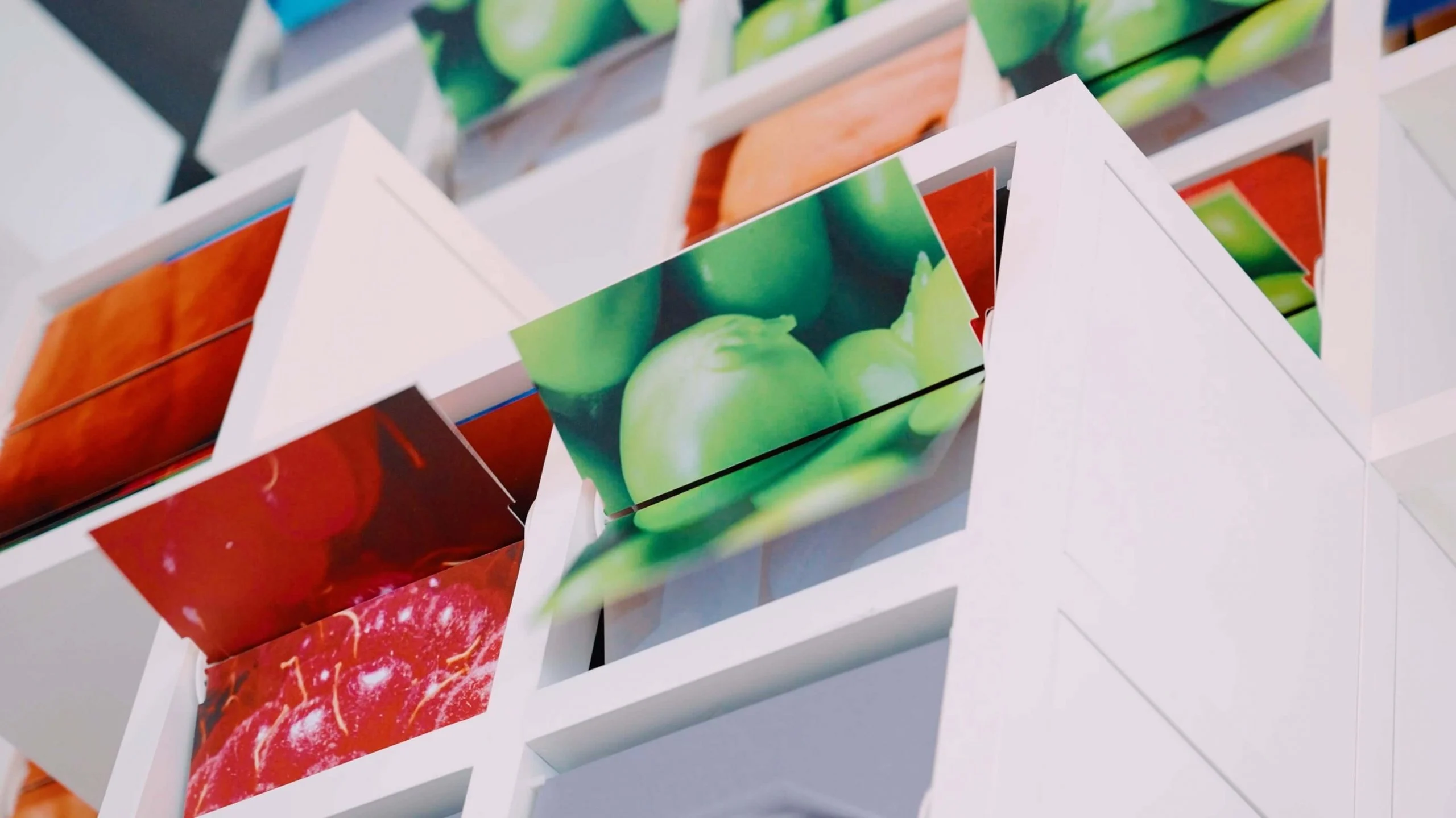 Dettaglio dei moduli de La Nuvola: cubi bianchi con palette rotanti che mostrano fotografie di frutta – La Nuvola al Cirfood District, Reggio Emilia, Italia, 2022 – progettazione di installazioni cinetiche