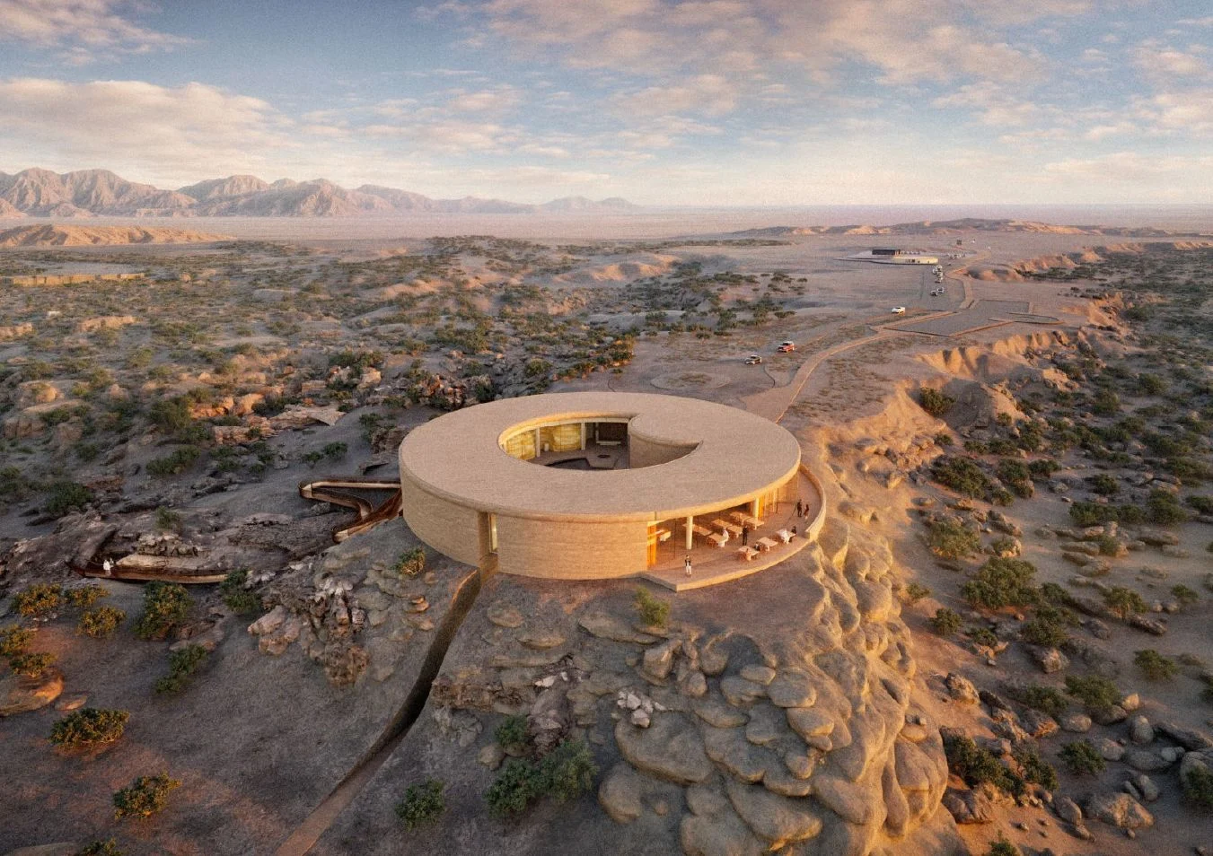 Render aereo dell'edificio ad anello attorno a un cortile centrale, su uno sperone roccioso nella valle desertica – Centro visitatori e manifattura Ayn Dawkah, Wadi Dawkah, Oman, 2025 – architettura, in costruzione